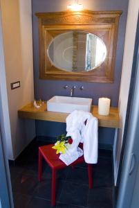 a bathroom with a sink and a table with a towel at Relais Borgo del Gallo in Acqui Terme +39 photos