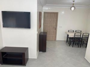 a living room with a flat screen tv on a wall at Appartement meublé proche de la mer à Agadir in Agadir