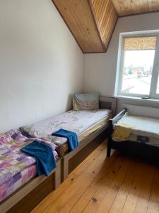 a bedroom with two twin beds and a window at Домашній Затишок in Stryi