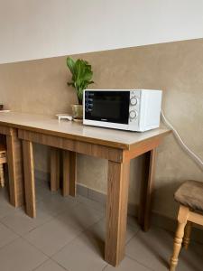 a microwave sitting on top of a wooden table at Домашній Затишок in Stryi