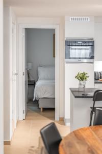 a living room with a bed and a kitchen at Milano Ostend - Casselbergh Residences in Ostend +16 photos