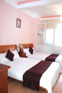 Giường trong phòng chung tại New Sleep in Dalat Hostel