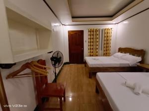Postel nebo postele na pokoji v ubytování Rabang Traveller's Inn