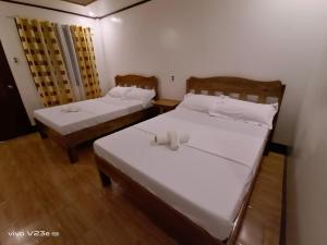 Postel nebo postele na pokoji v ubytování Rabang Traveller's Inn
