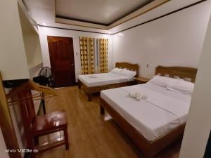Postel nebo postele na pokoji v ubytování Rabang Traveller's Inn