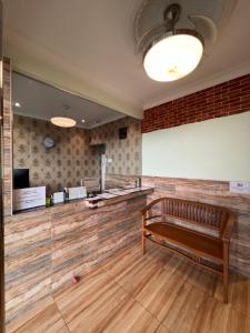 a waiting room with a bench in front of a screen at I Go Inn in Bandar Saujana Putra