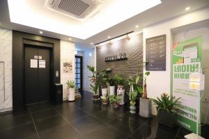 a lobby with a bunch of potted plants at Wolgot Unique Hotel 28 in Siheung