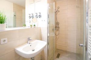 a bathroom with a sink and a shower at Chic Studio - 1min zum HBF in Mannheim +12 photos