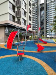 a playground with a slide on a blue carpet at Rizky D'Bali Homestay @ Bali Residents Melaka in Melaka