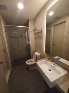 a bathroom with a toilet and a sink and a shower at Rizky D'Bali Homestay @ Bali Residents Melaka in Malacca