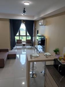 a living room with a couch and a table in a room at Rizky D'Bali Homestay @ Bali Residents Melaka in Melaka