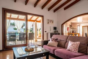 a living room with a couch and a table at Elegant Villa in Ciutadella de Menorca with Private Pool in Sa Caleta