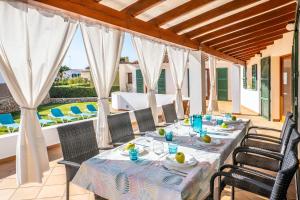 a dining room with a table and chairs at Elegant Villa in Ciutadella de Menorca with Private Pool in Sa Caleta +15 photos