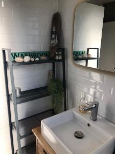 La salle de bains est pourvue d'un lavabo, d'un miroir et d'une étagère. dans l'établissement Country house - 5 mns from Fontainebleau, 
