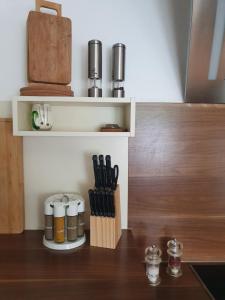 a kitchen counter with a knife block and utensils at FeWo Stegenbach Oberstaufen/Steibis in Oberstaufen