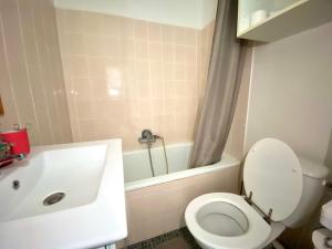 W łazience znajduje się biała toaleta i wanna. w obiekcie Appartement cozy w Montpellier