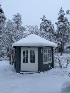 a small shed with snow on top of it at Aurora Center 3 in Rovaniemi +29 photos