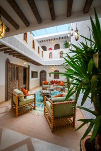 a living room with two couches and a table at Riad Cologne & Spa in Marrakesh