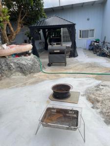 a grill in a yard with a black tent at Star & Moon GUEST HOUSE in Hengchun South Gate