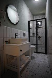 a bathroom with a sink and a toilet and a mirror at Mare House Boutique Hotel in Bursa