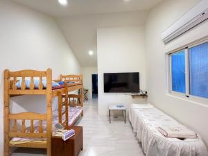 a room with two bunk beds and a flat screen tv at Star & Moon GUEST HOUSE in Hengchun South Gate +10 photos