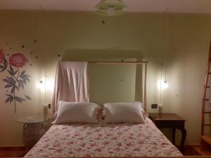 a bedroom with a bed with two pillows at VILLETTA TRA GLI ULIVI in Citta' Sant'Angelo