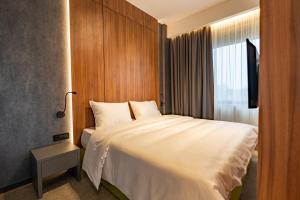 Un ou plusieurs lits dans un hébergement de l'établissement Hotel Element