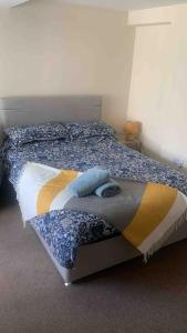 a bedroom with a bed with a comforter on it at Comfortable ground floor studio apartment. in Carlisle