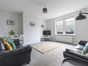 a living room with two couches and a tv at Hawthorn House - 2bedroom-Ashington Northumberland in Ashington