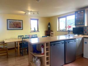 a kitchen with a counter top and a table at Princes point villa all on ground floor in Portree