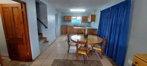a kitchen and dining room with a table and chairs at Swartberg Cottages in Prince Albert