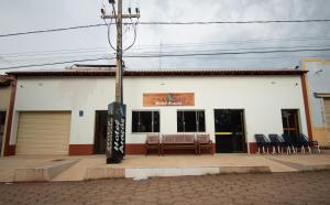 a building with a table and chairs in front of it at Hotel Araçás in Carolina