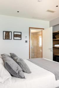 a white bedroom with a bed with pillows on it at Sea Tower Torre Telemetrica Lido di Venezia in Venice-Lido