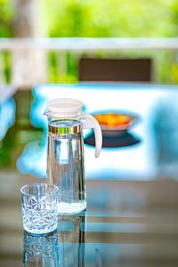 a glass jug of water sitting on a table at Chateau de Luxi Khao Yai - ชาโตว์ เดอ ลูซี่ เขาใหญ่ in Mu Si
