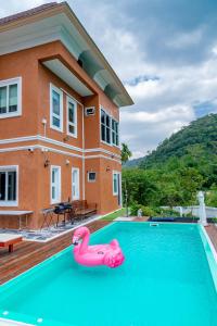 a house with a swimming pool with a pink flamingo in it at Chateau de Luxi Khao Yai - ชาโตว์ เดอ ลูซี่ เขาใหญ่ in Mu Si