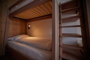 a bedroom with a bunk bed and a ladder at Ostello Scudellate by Stay Generous in Scudellate