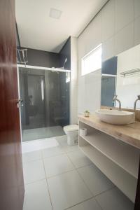 a bathroom with a sink and a shower and a toilet at Hotel Araçás in Carolina +50 photos