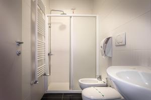 a bathroom with a shower and a toilet and a sink at Pasta Residence Italia Malpensa in Gallarate