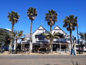 a building with palm trees in front of it at Orewa Lovely Cozy Home in Auckland