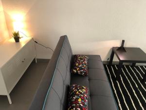 a living room with a couch and a table at Le Megève in Sainte-Croix-en-Plaine