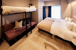 a bedroom with two bunk beds and a couch at Section L Hatchobori in Tokyo +33 photos