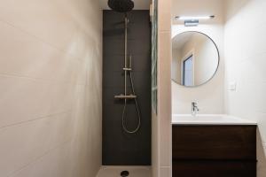 y baño con ducha, lavabo y espejo. en Atlantic Selection - Proche du golf - Parking Wifi, en Capbreton