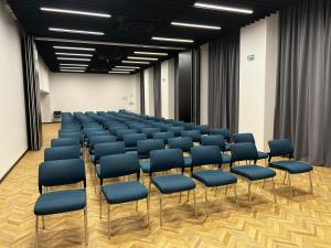 a conference room with blue chairs in the middle at Hotel Campus 90 - Free Parking in Varna City