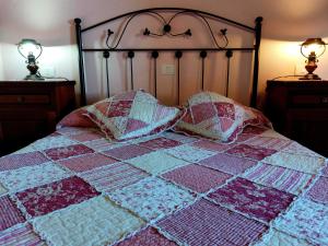a bed with a quilt and two pillows on it at Panchita in Garafía