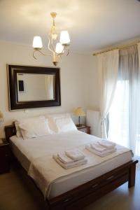 a bedroom with a bed with towels on it at Luxury Dafnis House in Veria