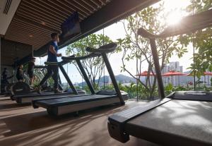 a man running on a treadmill in a gym at Amari SPICE Penang in Bayan Lepas