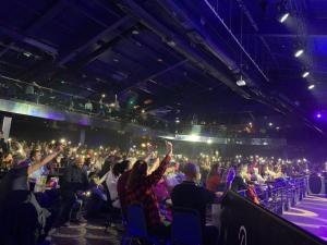 a crowd of people sitting in a theatre with their hands in the air at BUTLINS SKEGNESS, 3 Beds, Pet Friendly - The Paddock in Lincolnshire