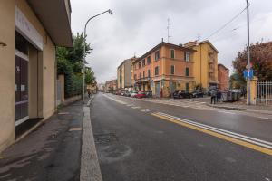 an empty street in a city with buildings at Casa Melo Mini House in Bologna