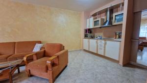 a living room with a couch and a kitchen at Apartment 24 in Pamporovo