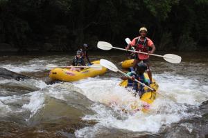 a group of people in rafts in a river at Lions Rock Rapids - Lodge in Hazyview